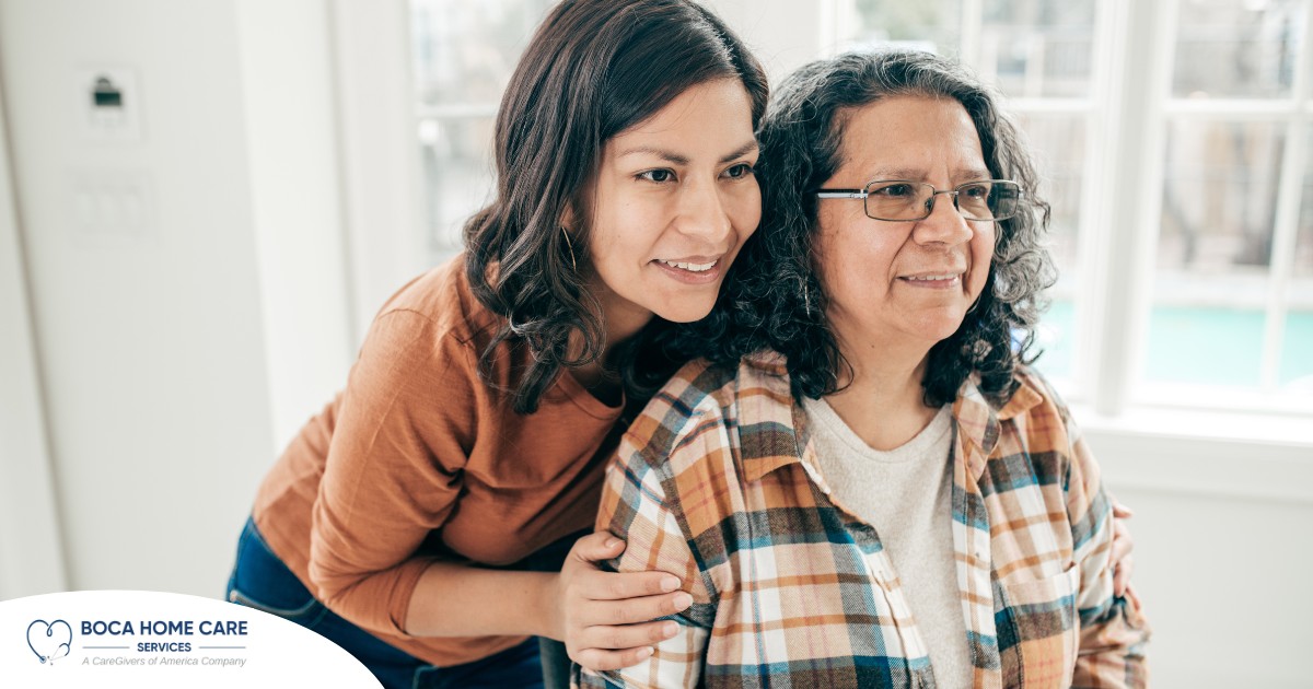 A woman hugs her older mother, representing compassionate senior care.