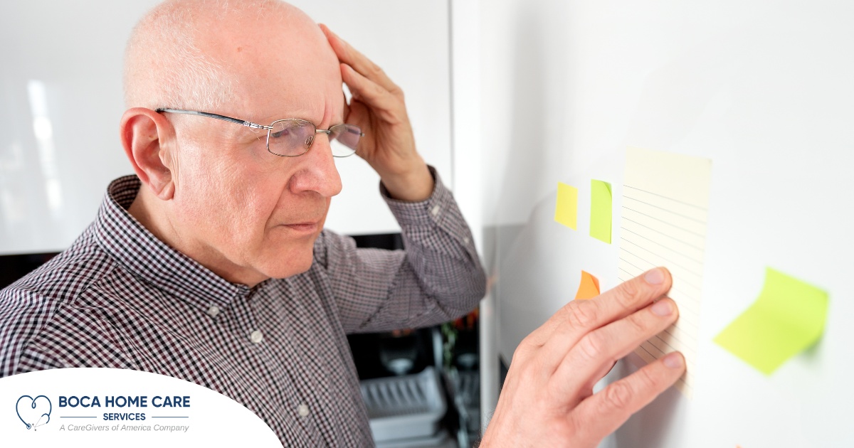 A senior looks at a board confused, representing one of the potential signs of dementia.