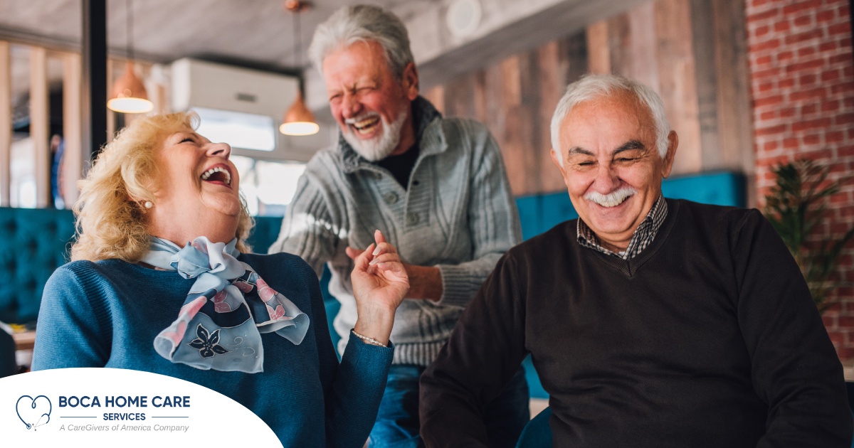 Older adults laugh and enjoy each other’s company representing how socialization can help seniors.